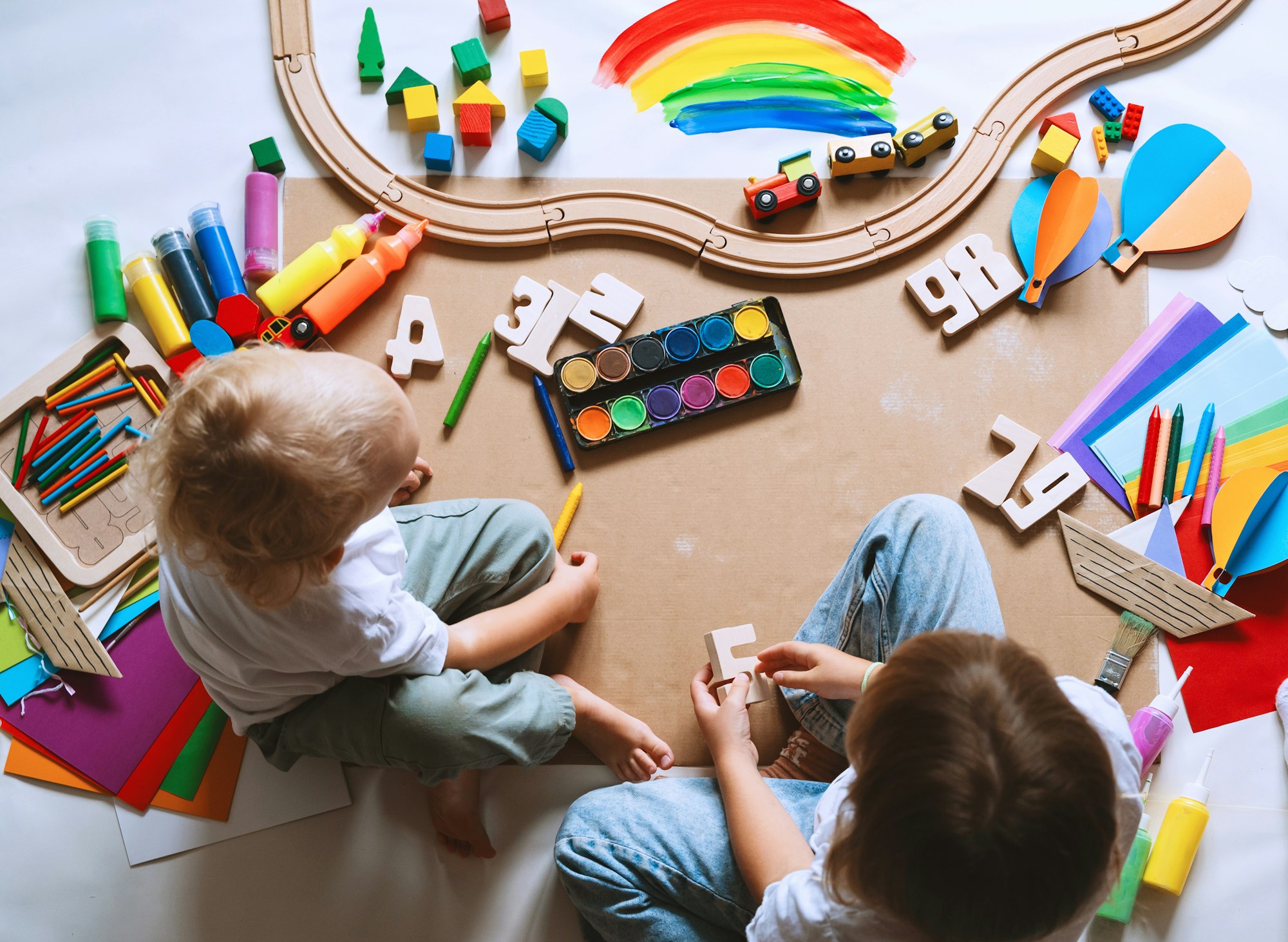 Children drawing and making crafts in kindergarten or daycare.